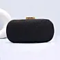 Woman Black Based Shiny Fabric Capsule Shaped Clutch