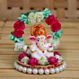 Polyresin Lord Ganesha Idol on Decorative Handcrafted Plate with Throne of Colorful Flowers