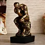 Golden Polyresin Antique Finish Thinking Man Figurine Sitting on Rock Handcrafted Decorative Showpiece