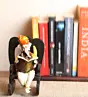 Orange Polyresin Lord Ganesha Idol reading Book on Wooden Chair