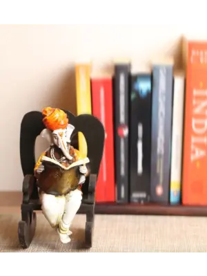 Orange Polyresin Lord Ganesha Idol reading Book on Wooden Chair