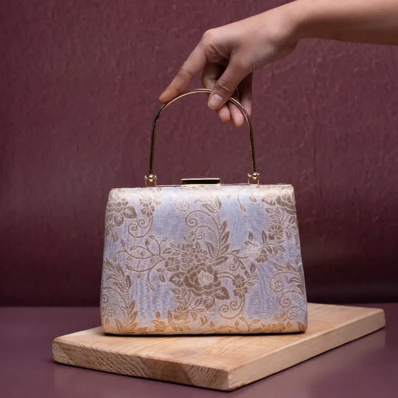 Woman White Based Golden Floral Brocade Fabric Clutch